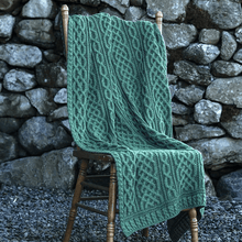 Load image into Gallery viewer, Plaited Merino Wool Aran Throw Green Color Lifestyle Tara